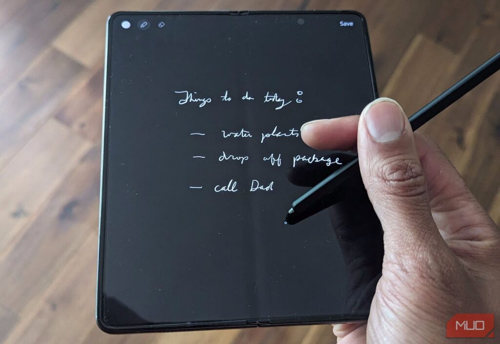 A man with a Samsung Galaxy Z Fold with an S Pen showing the Samsung Notes app